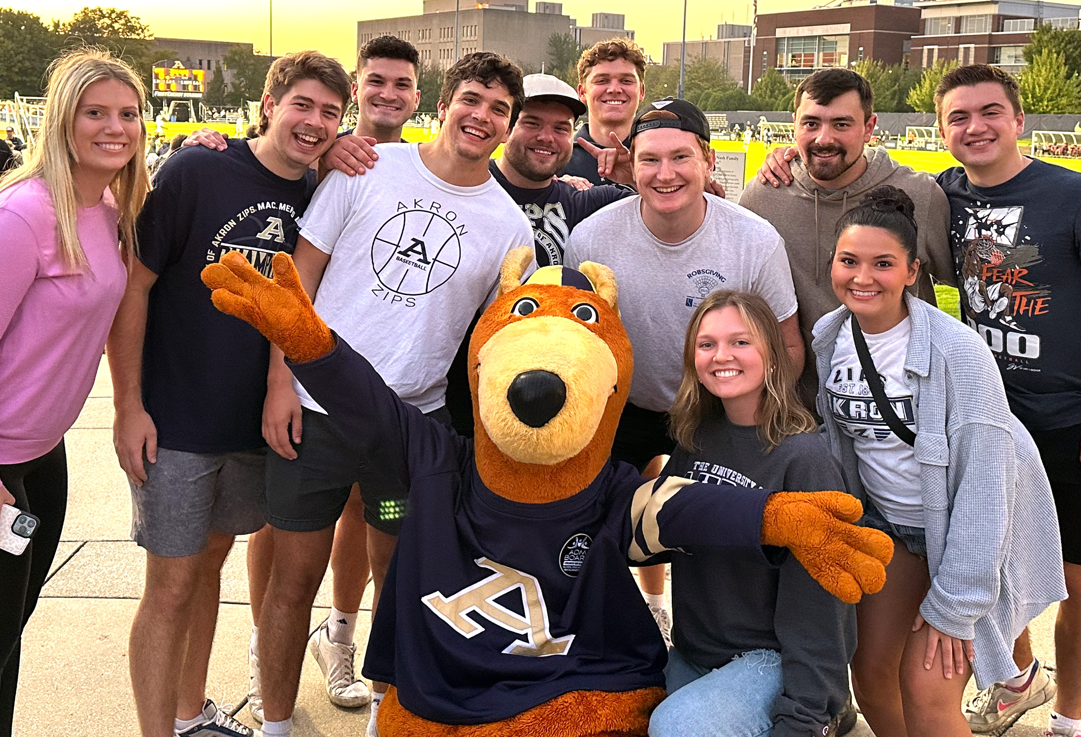 Students on campus taking a picture with Zippy