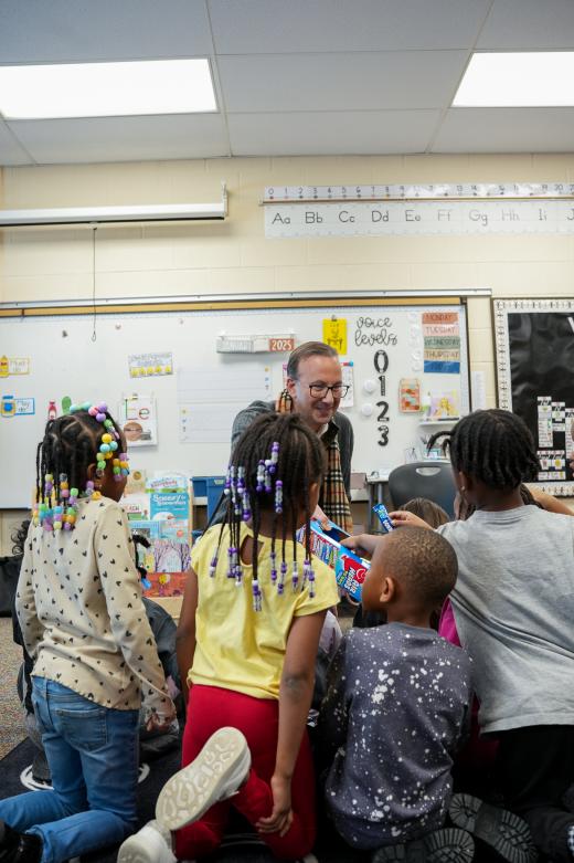 President R.J. Nemer reads to kindergarten students at Helen Arnold Community Learning Center