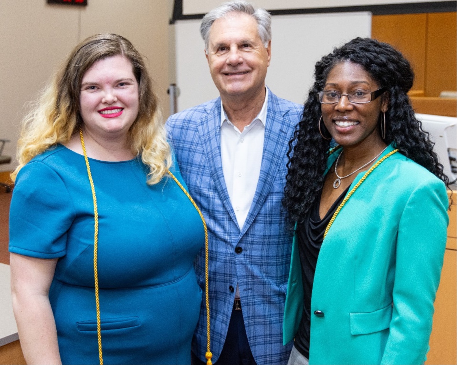 Chris Nolan of Perantinides & Nolan with award winners Kelsey Jennings and Allyson Strickland.